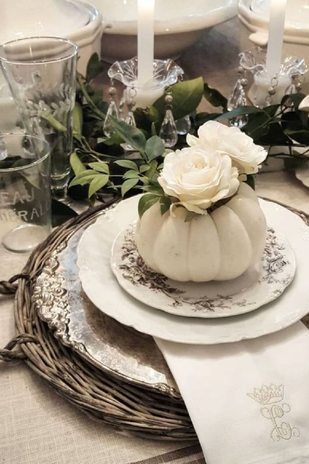 Elegant Thanksgiving placesetting with white pumpkin and white roses plus ironstone and brown transferware plates - @thefrenchnestcointeriordesign. #falltable #thanksgivingtablescape