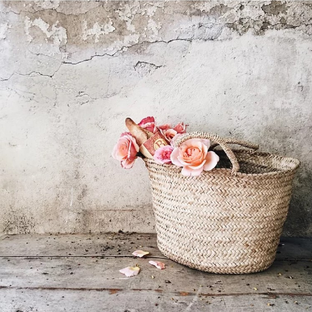 Rustic French country style basket with peachy roses against a crumbling ancient stone wall - Vivi et Margot. #frenchfarmhouse #frenchbaskets #provencestyle