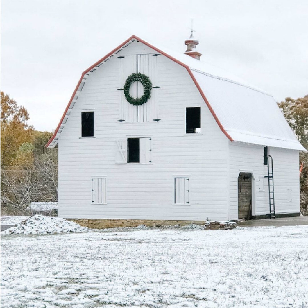 Magnificent white barn with Christmas wreath at a country property in Knoxville, TN - Beside the Mulberry Tree. #farmhousechristmas #whitebarns #whitechristmas