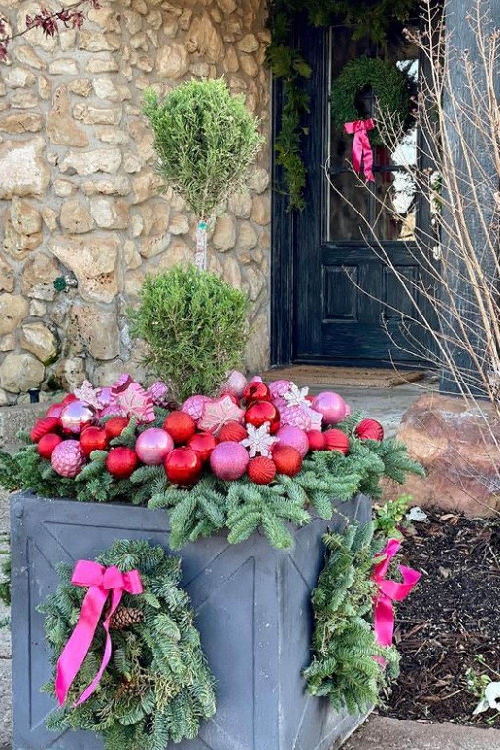 Beautiful Christmas planter with pinks and reds - @adornplanters. #christmasporches