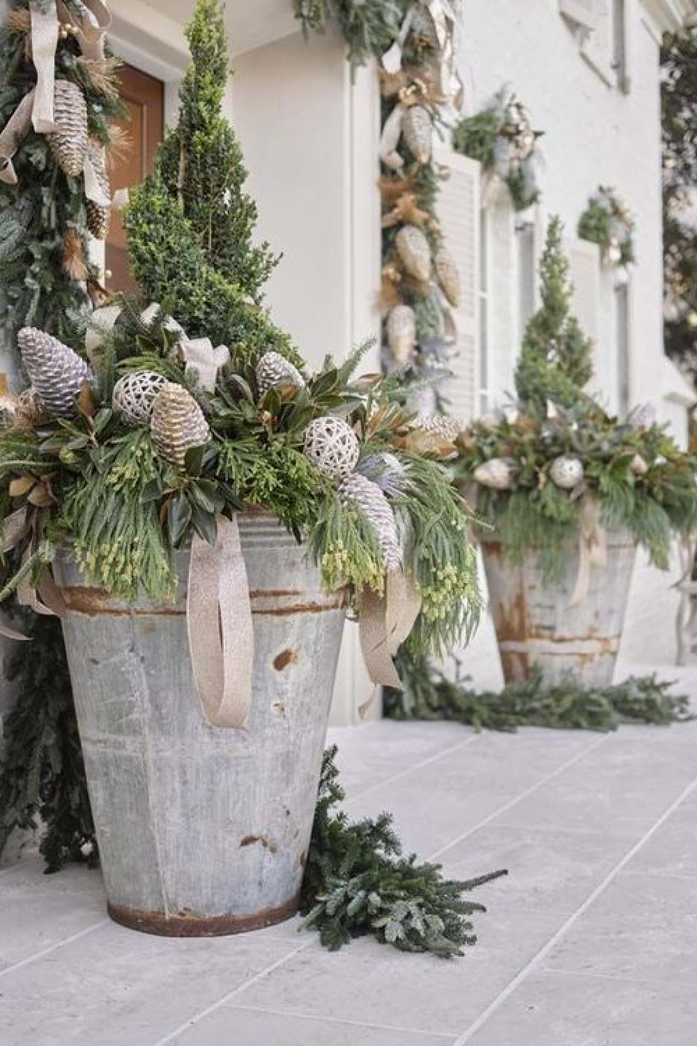 Magnificent Christmas decorated porch with large scale planters, fresh greenery, and ribbon - Home for Holidays Atlanta. #christmasporch #holidayhouse
