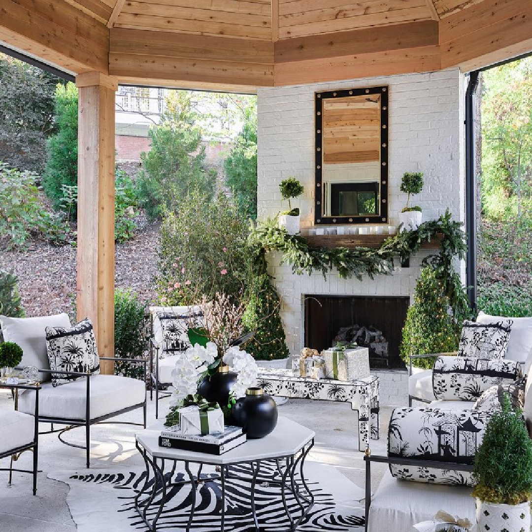 Atlanta Holiday Home covered patio with Christmas decorated fireplace - Sande Beck Design. #atlantaholidayhome #christmasfireplace