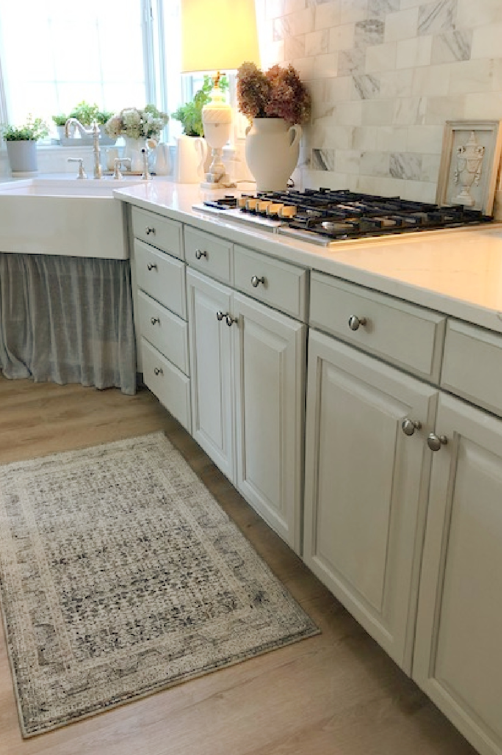 Modern French kitchen with Amber Lewis Zuma rug in ocean/multi near cooktop - Hello Lovely Studio.