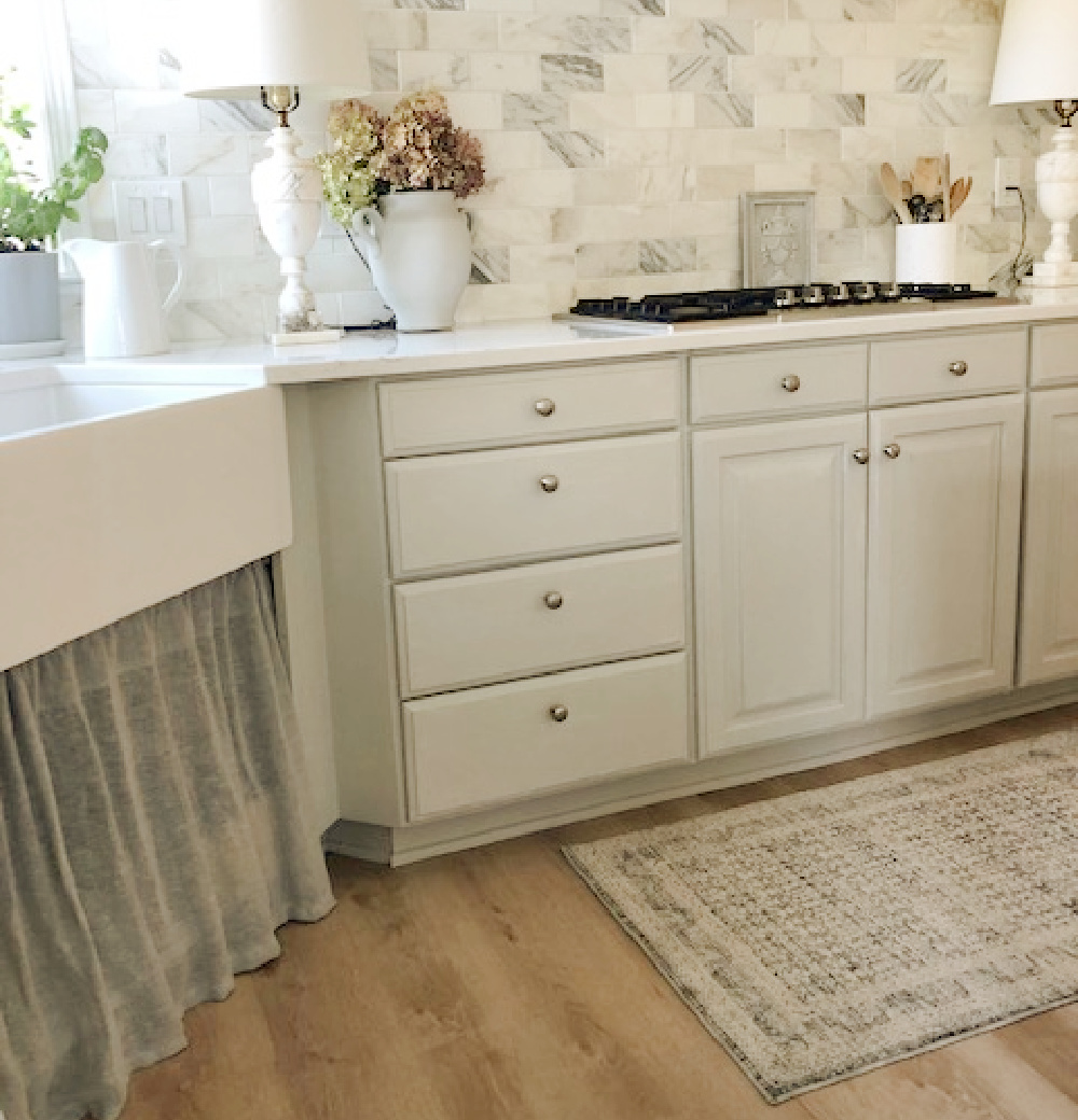 Modern French kitchen with Amber Lewis Zuma rug in ocean/multi near cooktop - Hello Lovely Studio.