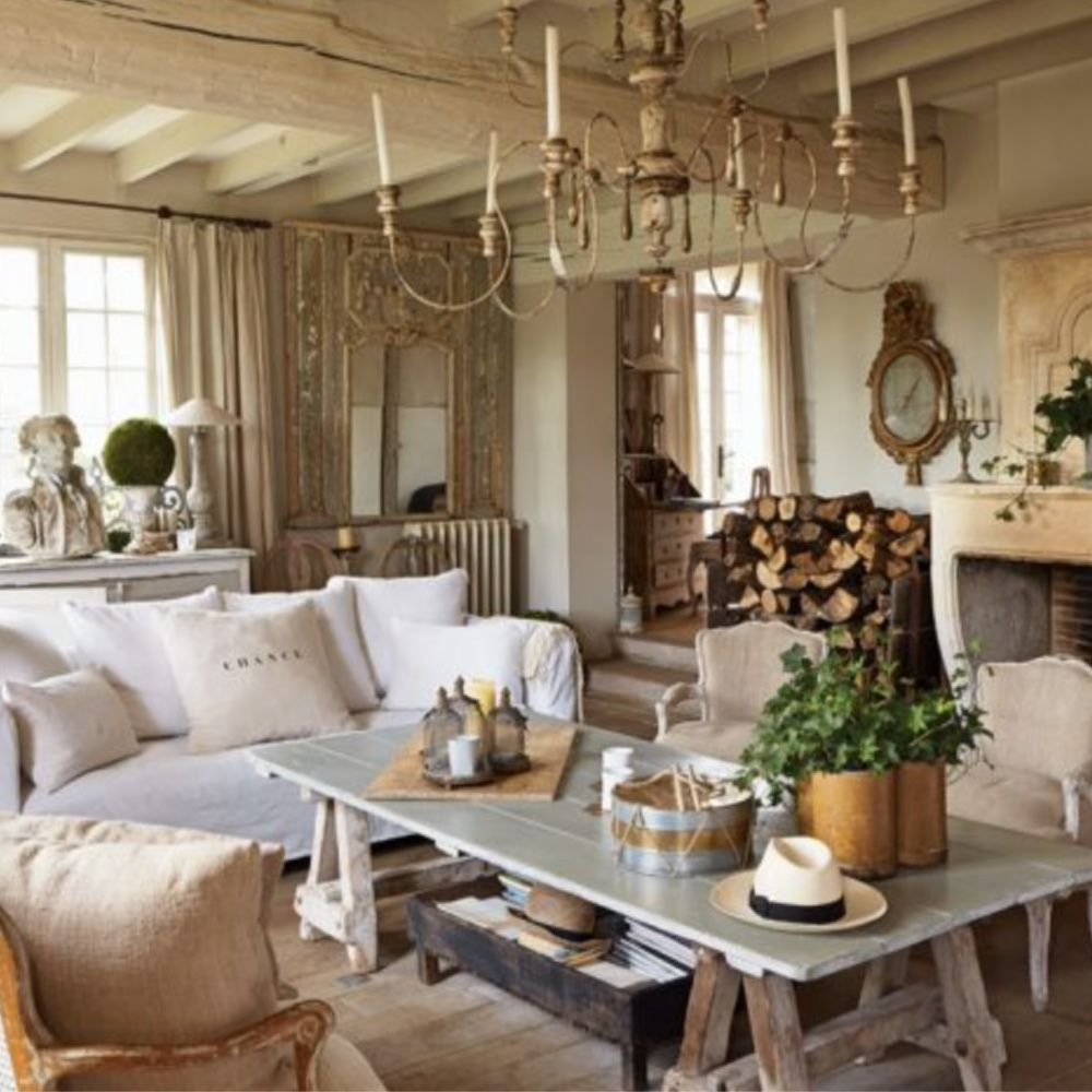 Elegant French Nordic living room with limestone fireplace, antiques from Au Temps Des Cerises and rustic wood ceiling - Sophie Lambert's home in VICTORIA magazine (photo by Louis Galliard).
