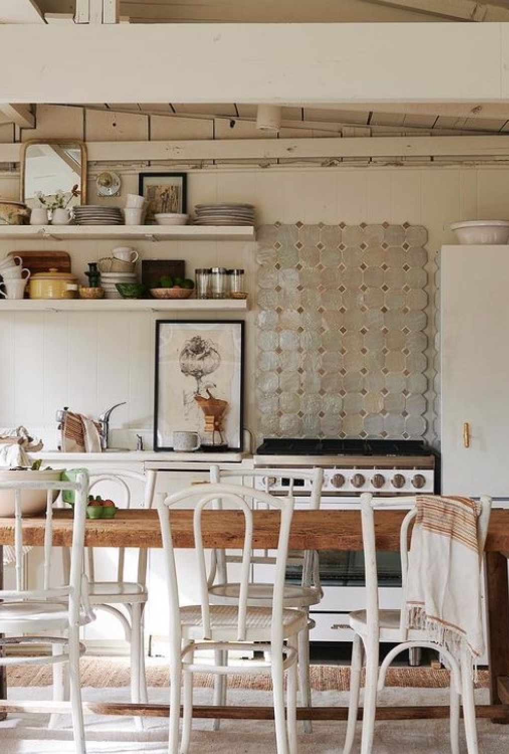 Rustic kitchen designed by Leanne Ford with white range and open shelves.