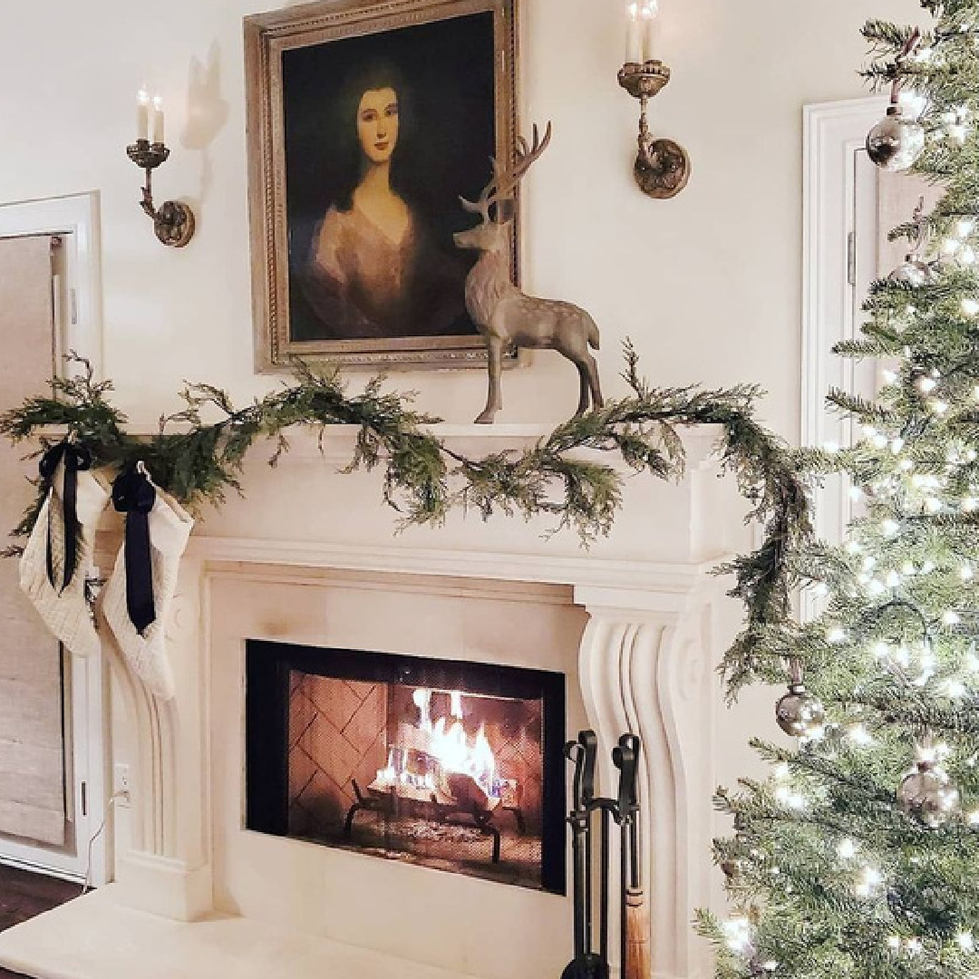 Elegant French country fireplace with garland, stockings, sconces, and portrait - The French Nest Co Interior Design. #frenchchristmas #elegantchristmas