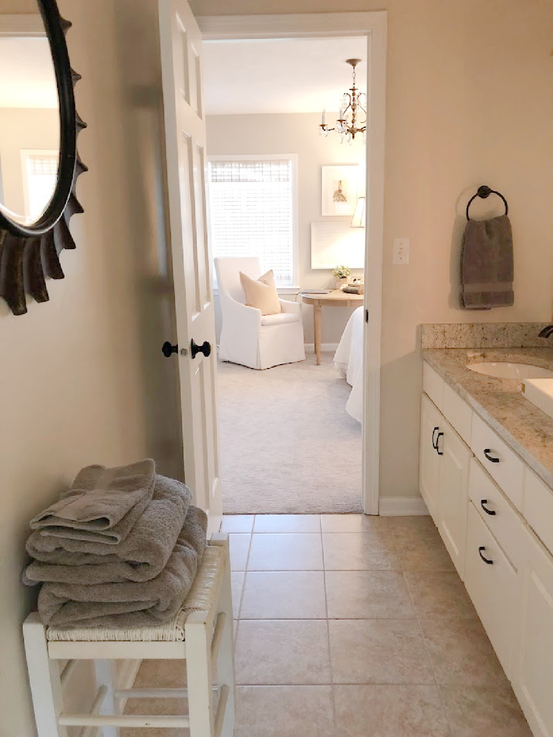 A traditional style bath with granite counters at our renovation was lightened up with paint (No Filter by Clare on walls) - Hello Lovely Studio.