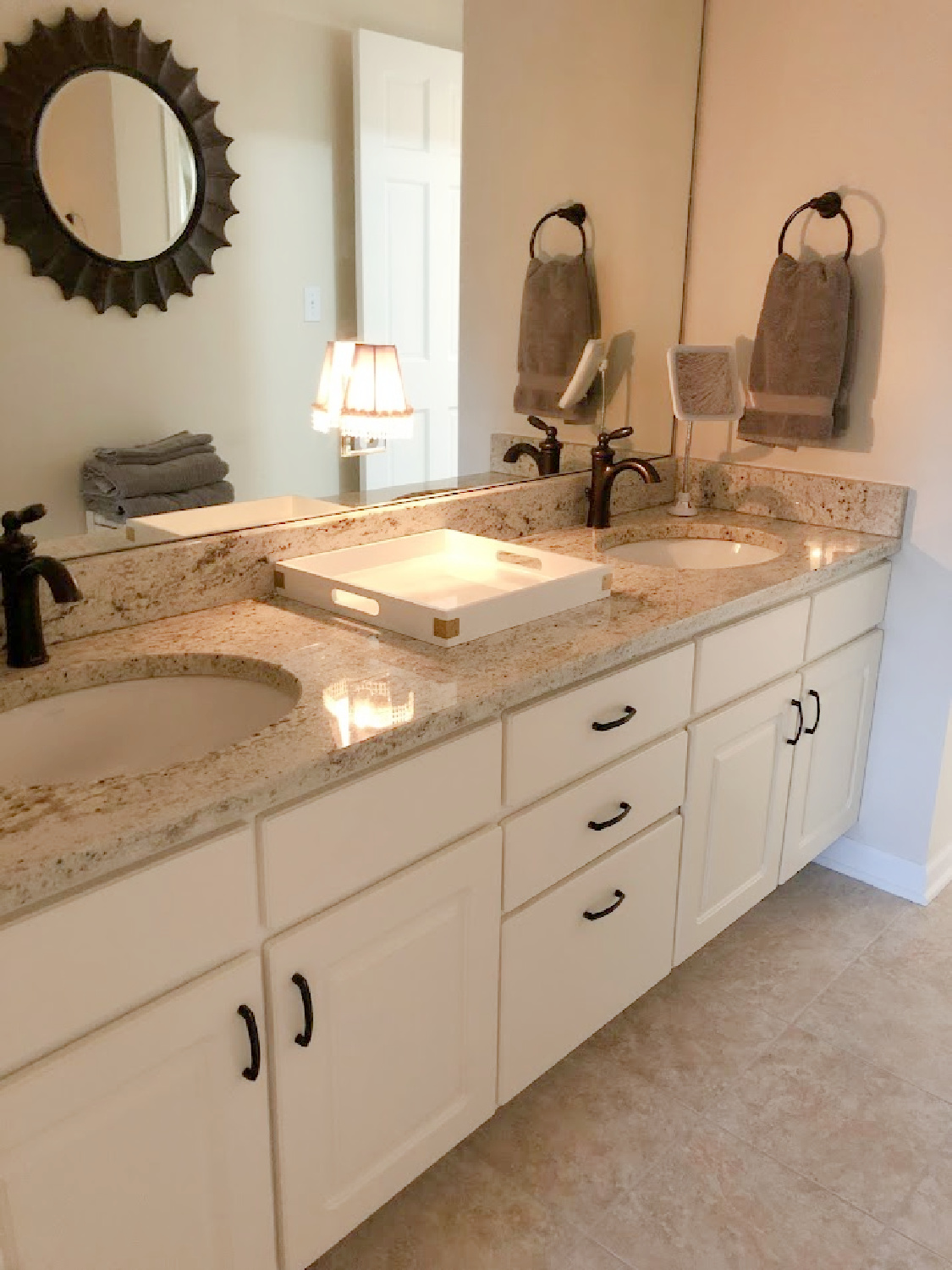 A traditional style bath with granite counters at our renovation was lightened up with paint (No Filter by Clare on walls) - Hello Lovely Studio.