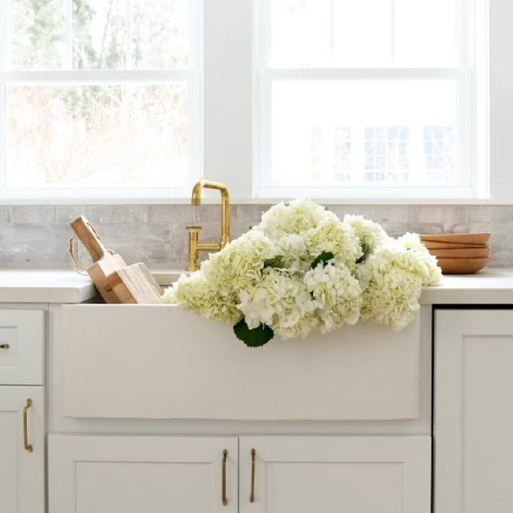 Leanne Ford designed rustic modern kitchen with white shelves, farm sink, and customized tile backsplash. #leanneford #modernrustic