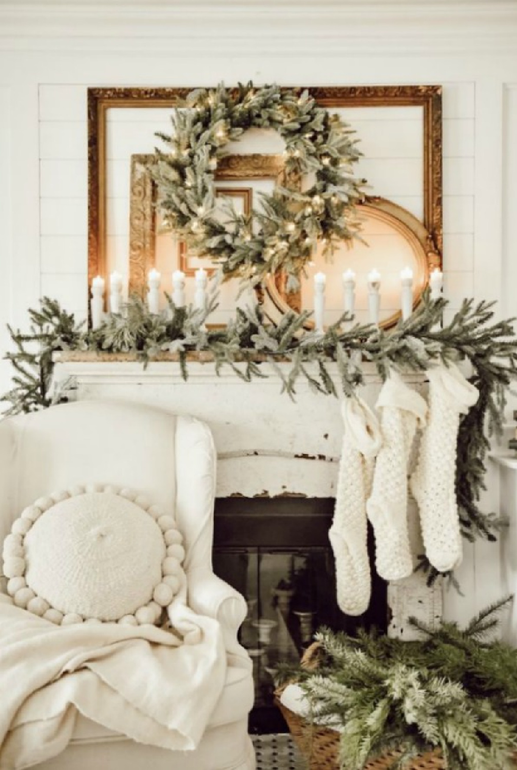Farmhouse Christmas fireplace decor with garland, stockings, wreath, and candlelight - Liz Marie Blog. #christmasfireplace #farmhousechristmas
