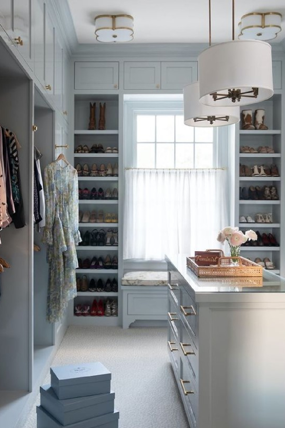 Gorgeous fantasy closet with builtins painted light blue and designed by Ann Wolf, architecture by Reagan Andre.