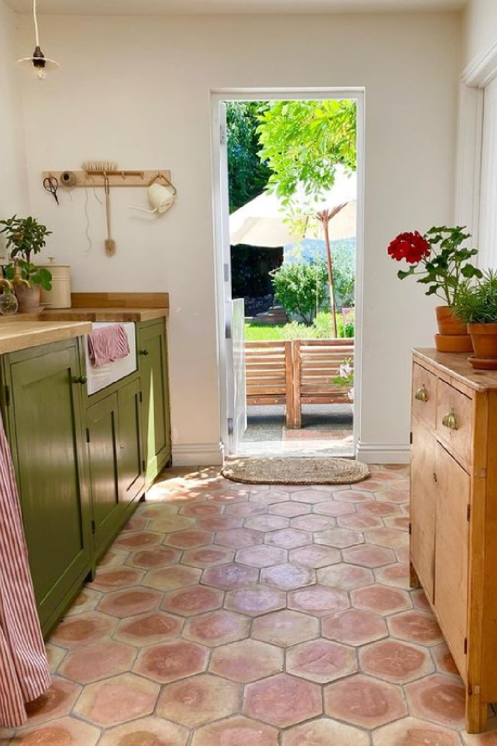 Strong White (Farrow & Ball) paint color on walls, Bancha on utility room cabinets. Hex terracotta tiles and vintage cupboard add so much charm - @littlewhitehouse. #strongwhite