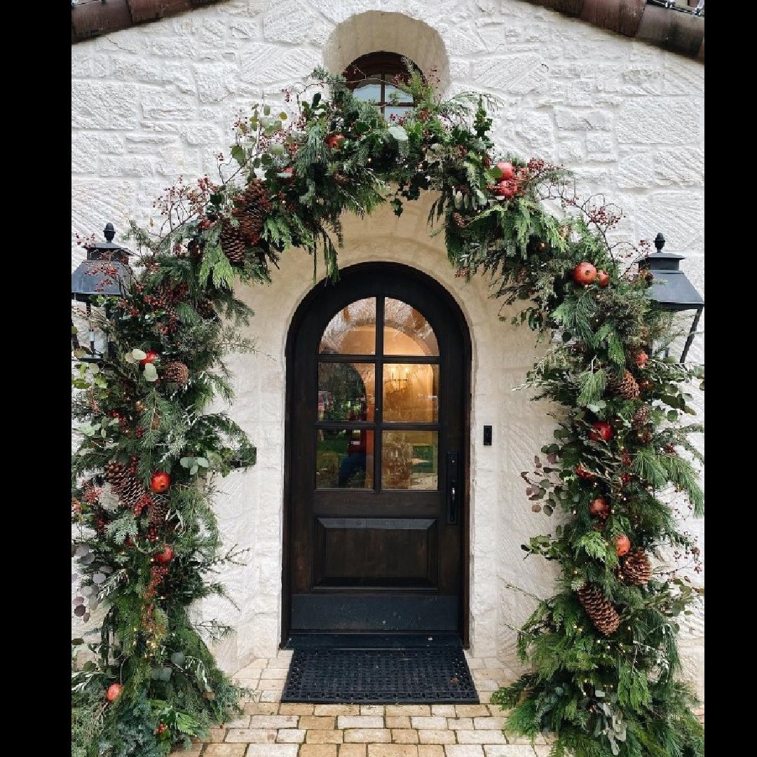 Beautiful Christmas garland on a an English cottage exterior with black arched door - @teressajohnson. #christmasgarland