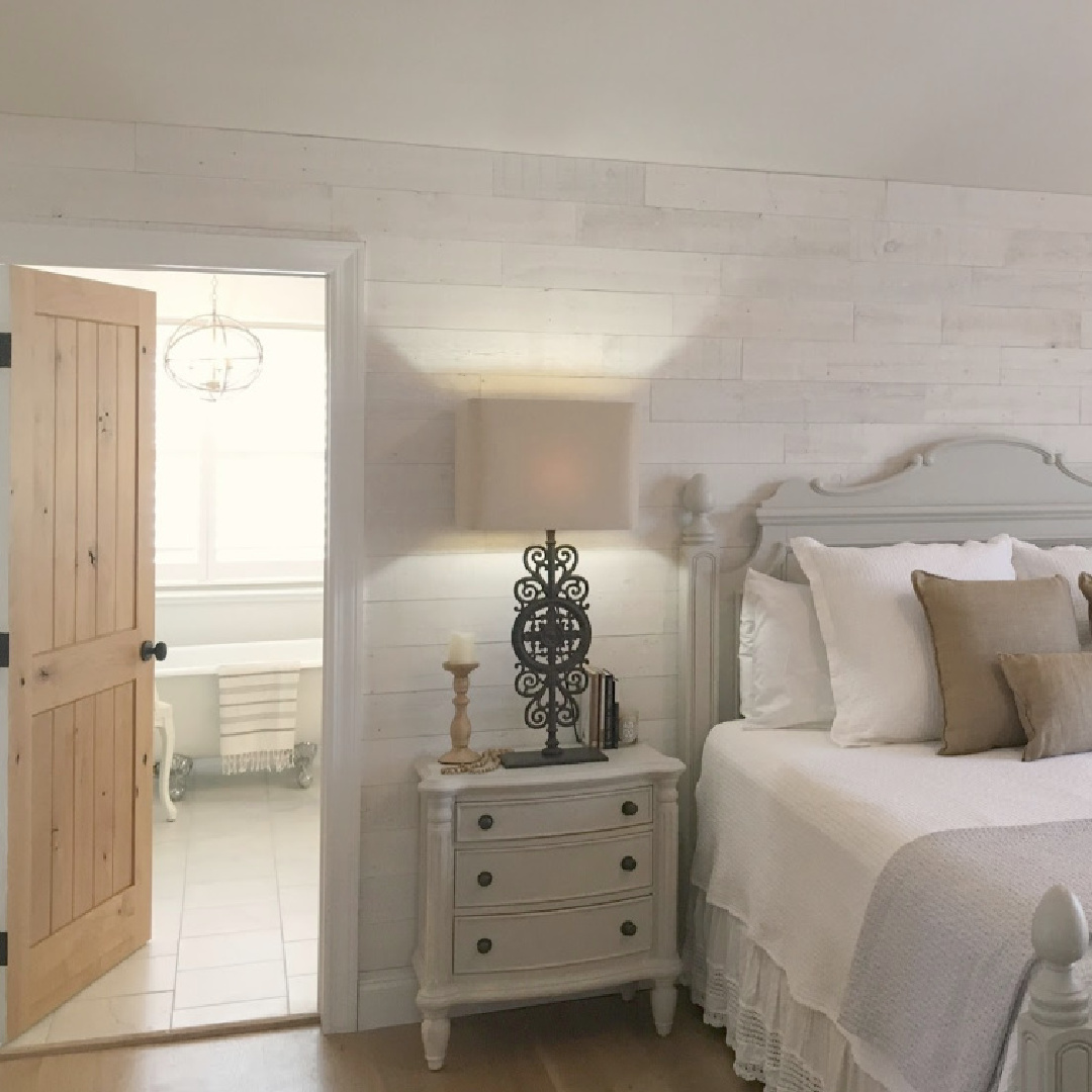 Neutral, serene, European country bedroom with Stikwood accent wall (Hamptons), white bedding, and BM Revere Pewter painted furniture - Hello Lovely Studio. #reverepewter #cottagebedroom