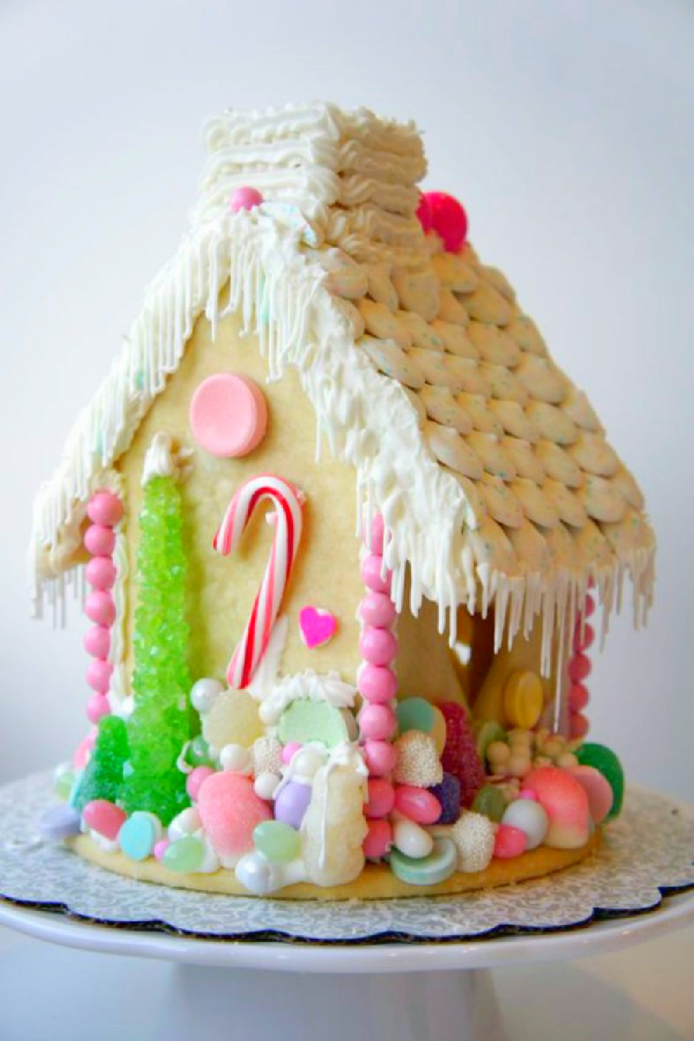 Fanciful gingerbread house made from sugar cookie dough and colorful candies.