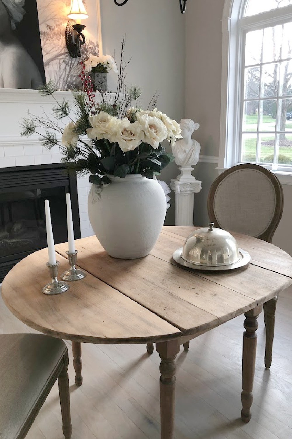 Antique srubbed wood oval dining table with large French urn and white roses - Hello Lovely Studio. #modernfrench #diningroom