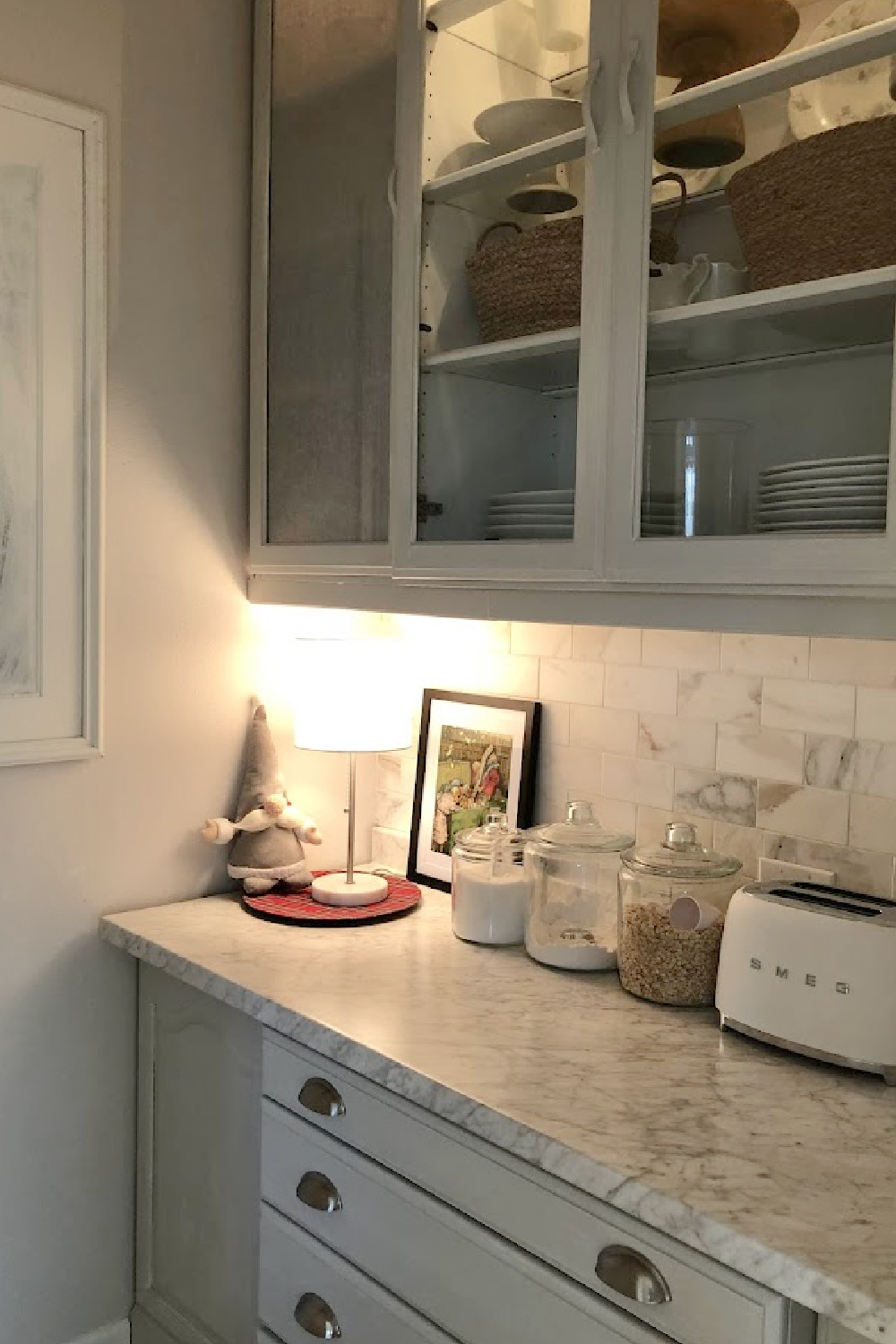 Inside the kitchen pantry is a built-in china cabinet I painted Pavilion Gray by Farrow & Ball. The backsplash is calacatta gold marble subway tile.