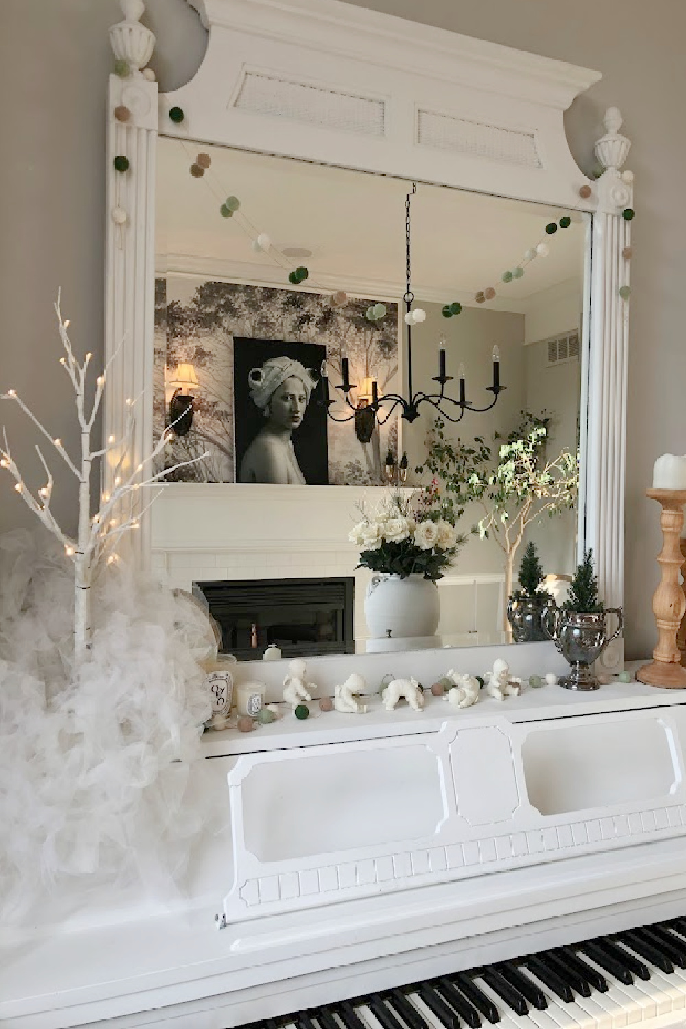 My vintage white piano decorated for holidays with snow babies, birch snowy tree, and felt garland - Hello Lovely Studio.