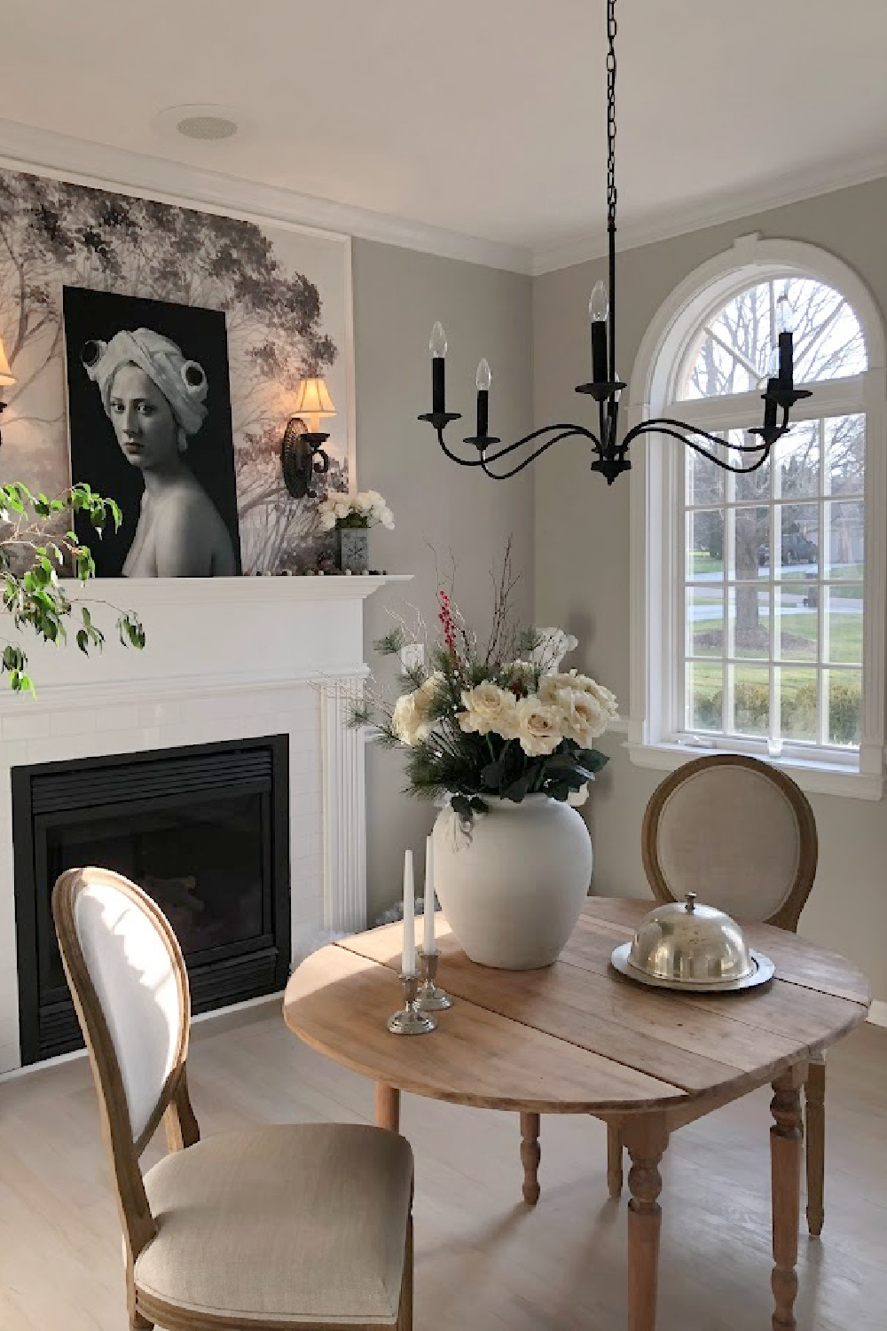 Our dining room with fireplace, white roses, tree wallpaper mural, and Repose Gray (Sherwin-Williams) on walls - Hello Lovely Studio. #modernfrench #diningroom