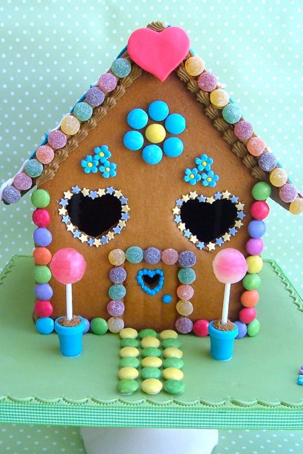 Adorable gingerbread house with hearts, stars, and pink