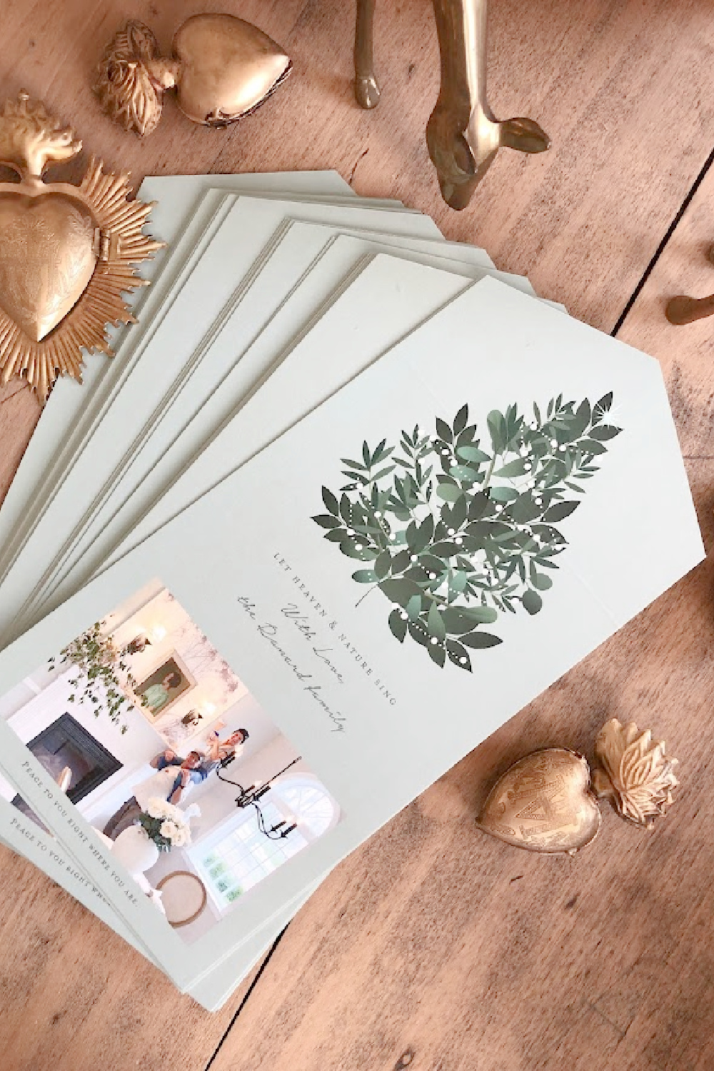 Minted photo Christmas card (Heaven and Nature Sing foldable design with perforated edge to remove photo) on dining room table with gold sacred milagros and vintage brass deer - Hello Lovely Studio. #mintedchristmascard