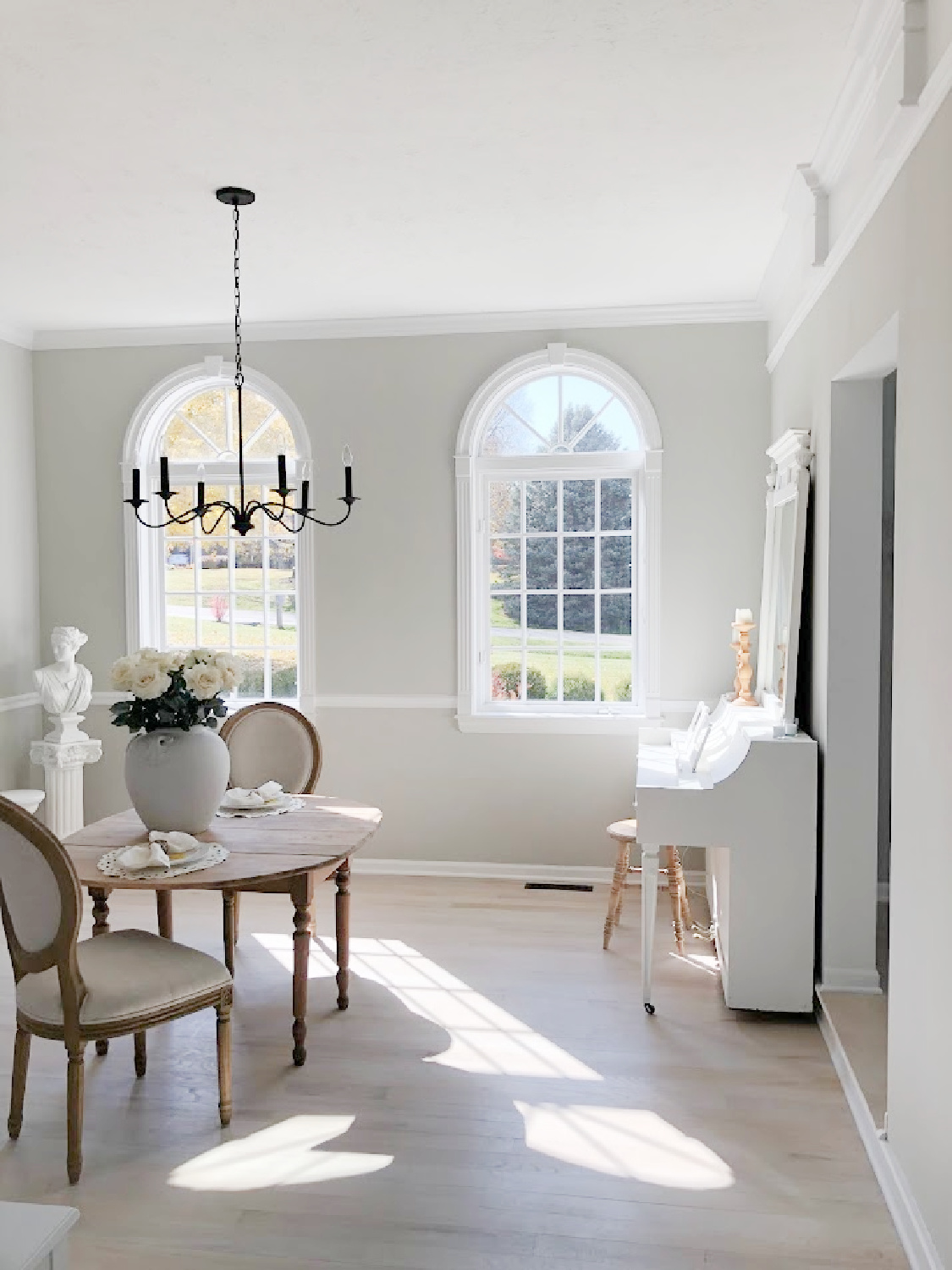 Dining room with classic style millwork, SW Repose Gray walls, and greyed oak hardwood floors - Hello Lovely Studio.