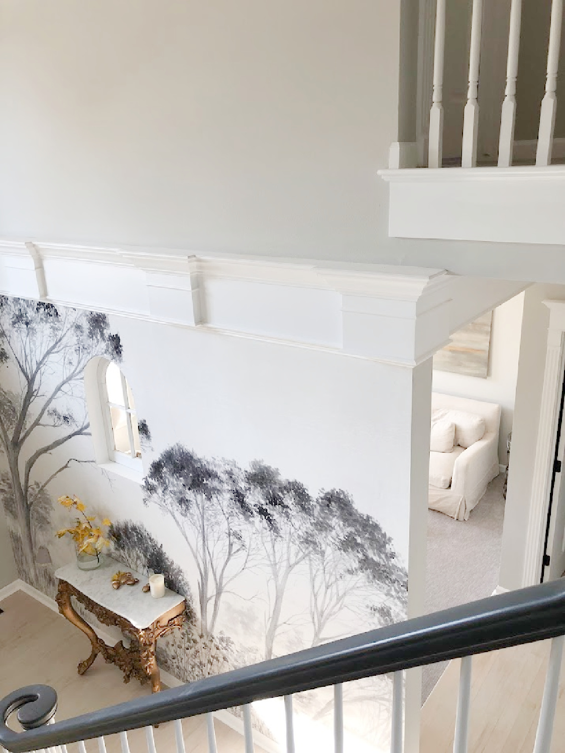 Renovated entry with dark gray doors (SW Carbonized), walls painted SW Repose Gray, tree mural (Photowall), and greyed oak hardwoods - Hello Lovely Studio.