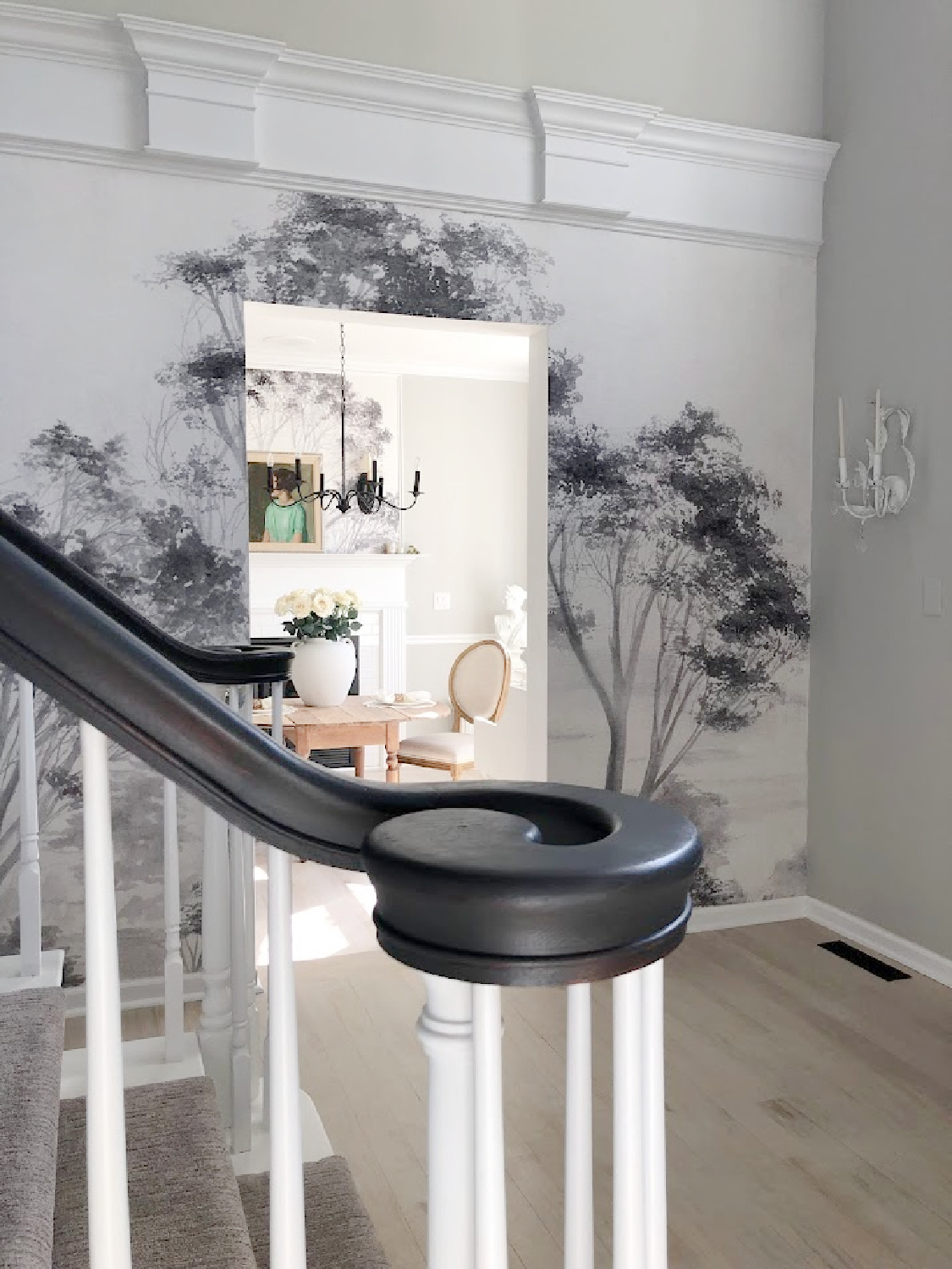 Renovated entry with dark gray doors (SW Carbonized), walls painted SW Repose Gray, tree mural (Photowall), and greyed oak hardwoods - Hello Lovely Studio.