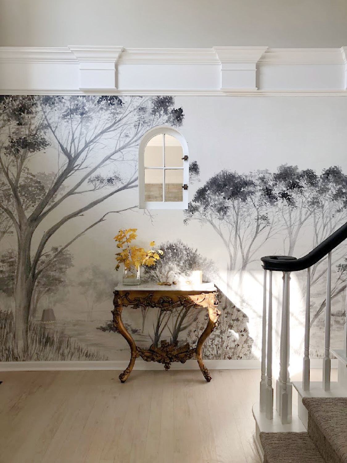 Renovated entry with dark gray doors (SW Carbonized), walls painted SW Repose Gray, tree mural (Photowall), and greyed oak hardwoods - Hello Lovely Studio.