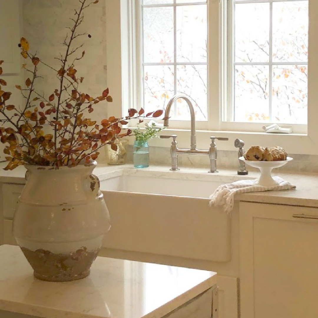 My kitchen with farm sink and small work cart with urn and fall branches - Hello Lovely Studio.