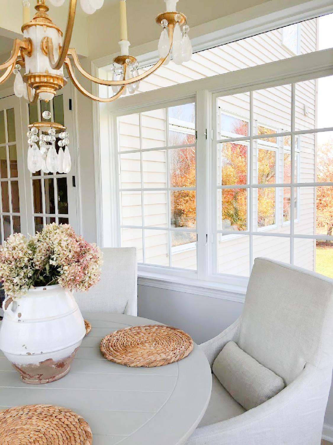 Fall leaves reflected in windows and breakfast room - Hello Lovely Studio.