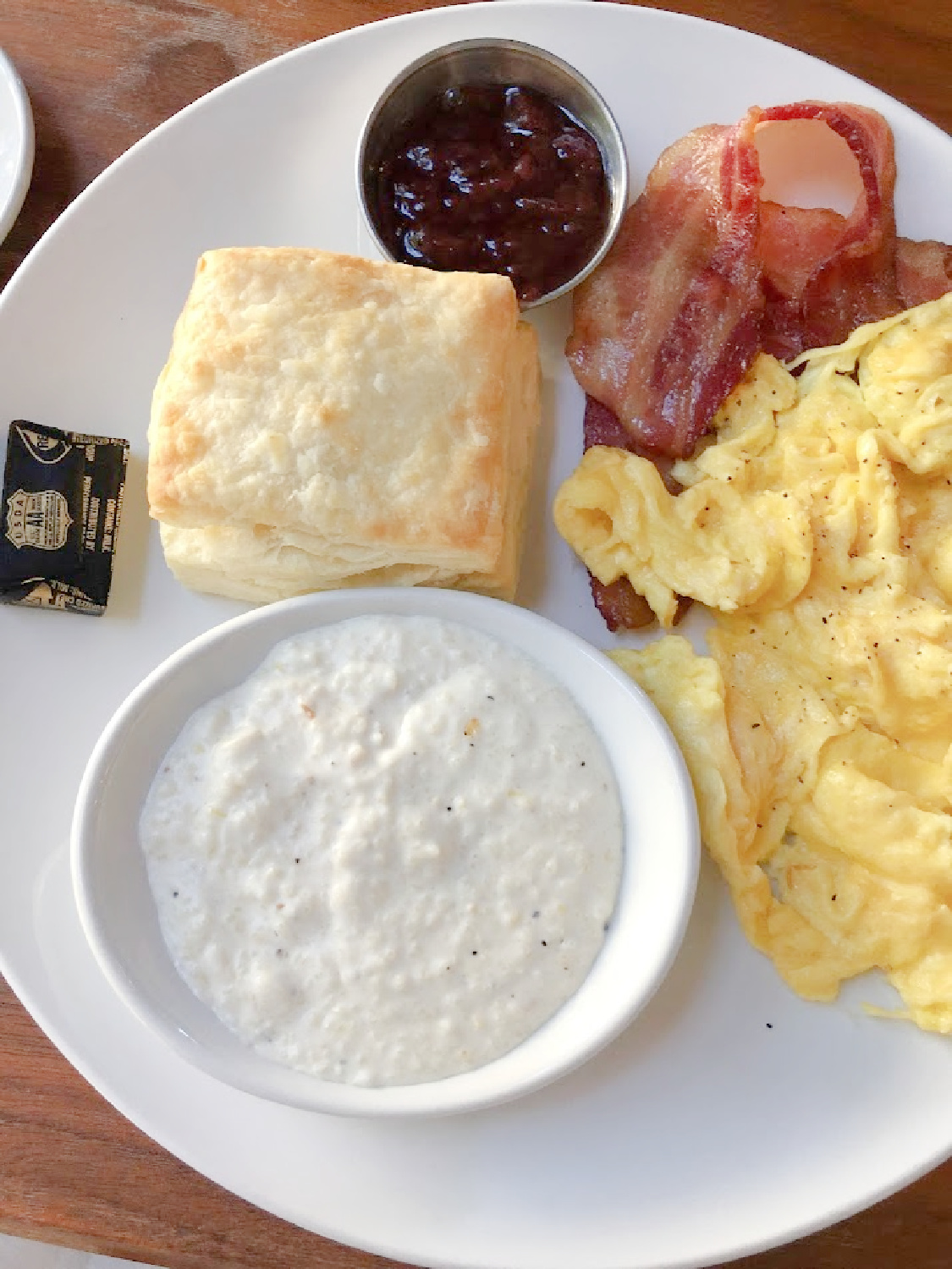 Franklin, TN Biscuit Love Egg plate with cheesy grits, scrambled, bacon and biscuit.