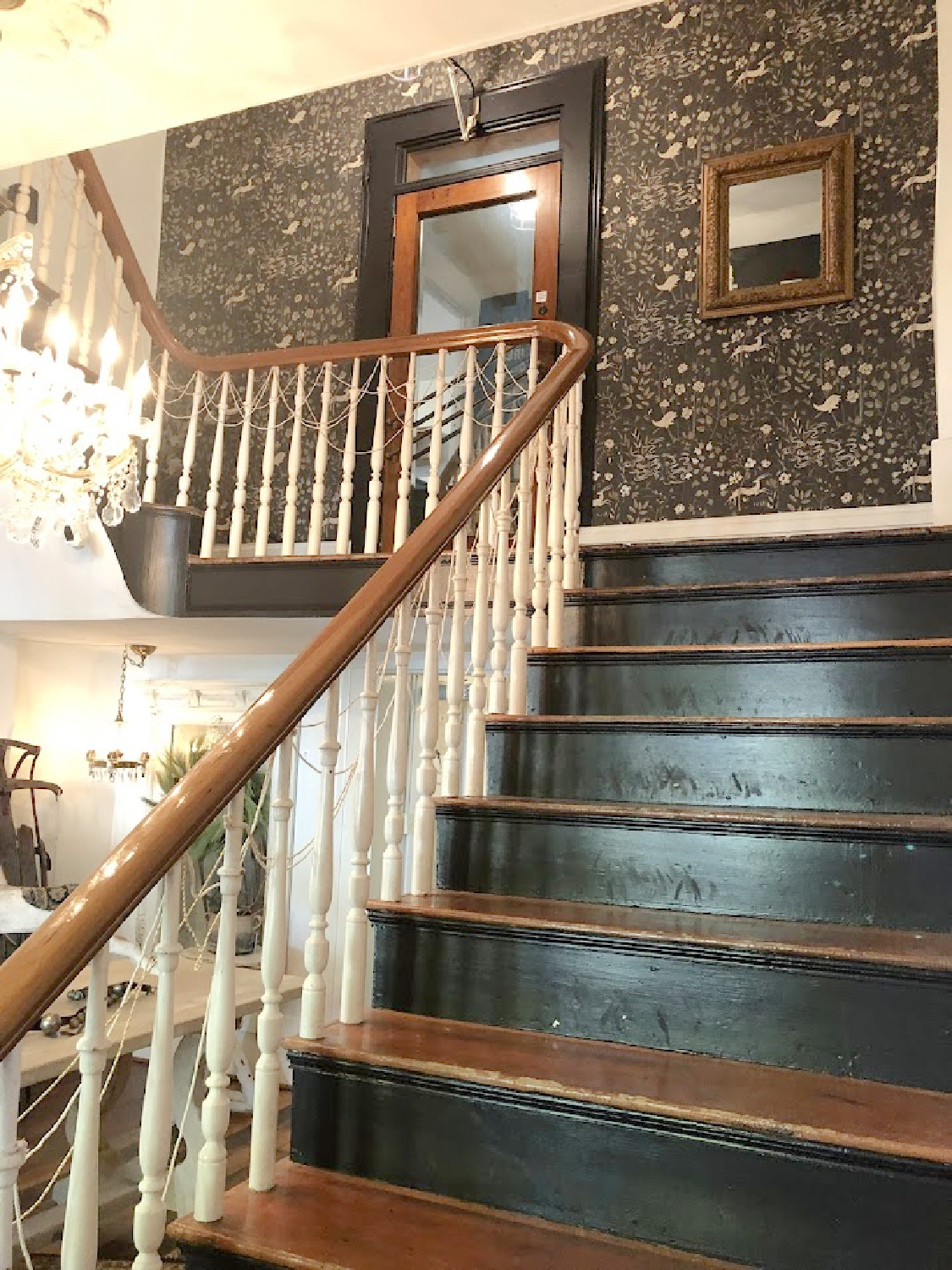Dark moody black stairs and folksy wallpaper within City Farmhouse shop in Franklin, TN - Hello Lovely Studio.