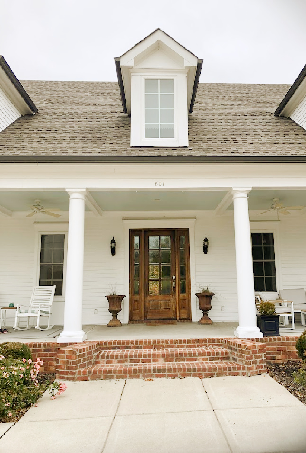 White traditional Southern cottage style home with wide front porch, columns and dormers - Franklin, TN - Hello Lovely Studio.