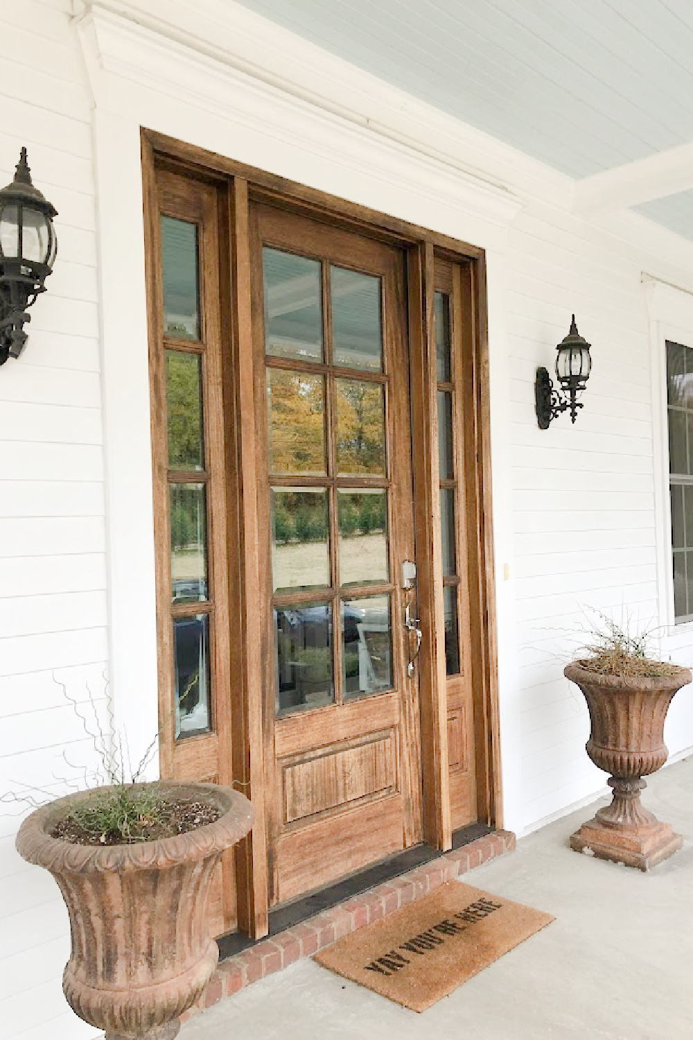 Front door with sidelights at white traditional Southern cottage style home with wide front porch and dormers - Franklin, TN - Hello Lovely Studio.