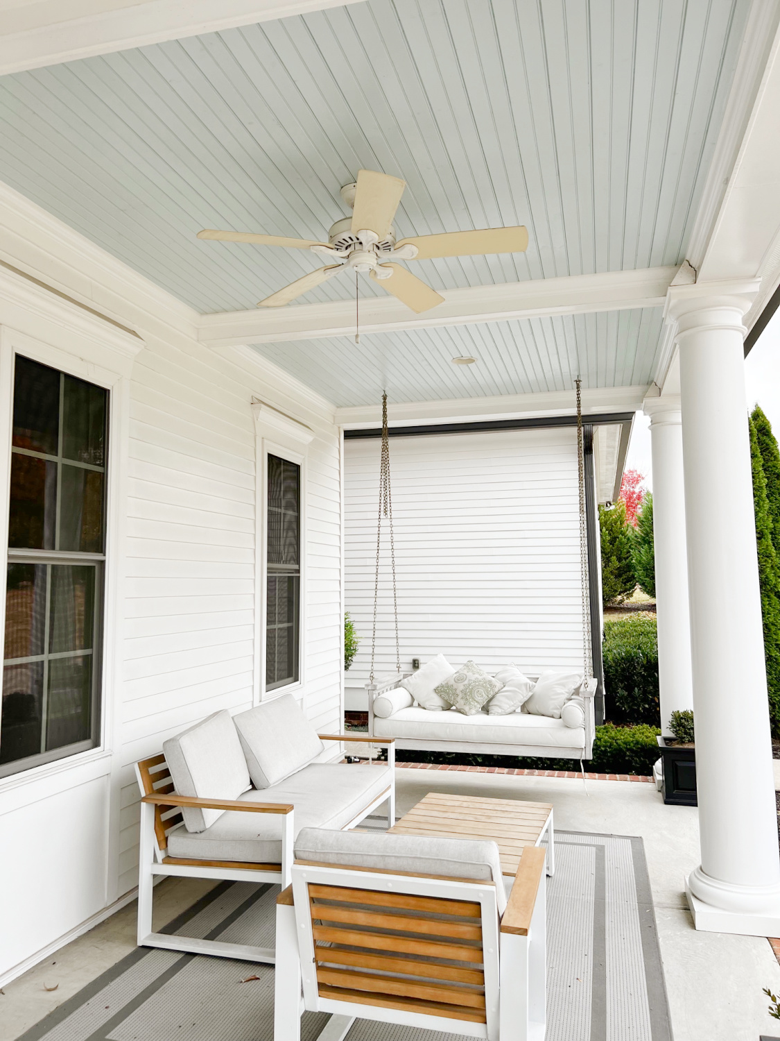 Beautiful Southern front porch in Franklin, TN with haint blue ceiling, columns, and porch swing - Hello Lovely Studio. #porchswing #southernporches #haintblue