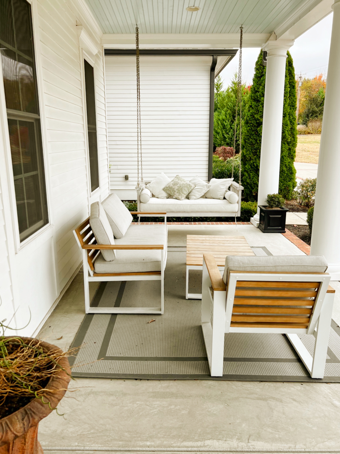 Beautiful upholstered porch swing bed on a Southern porch in Franklin, TN - Hello Lovely Studio.