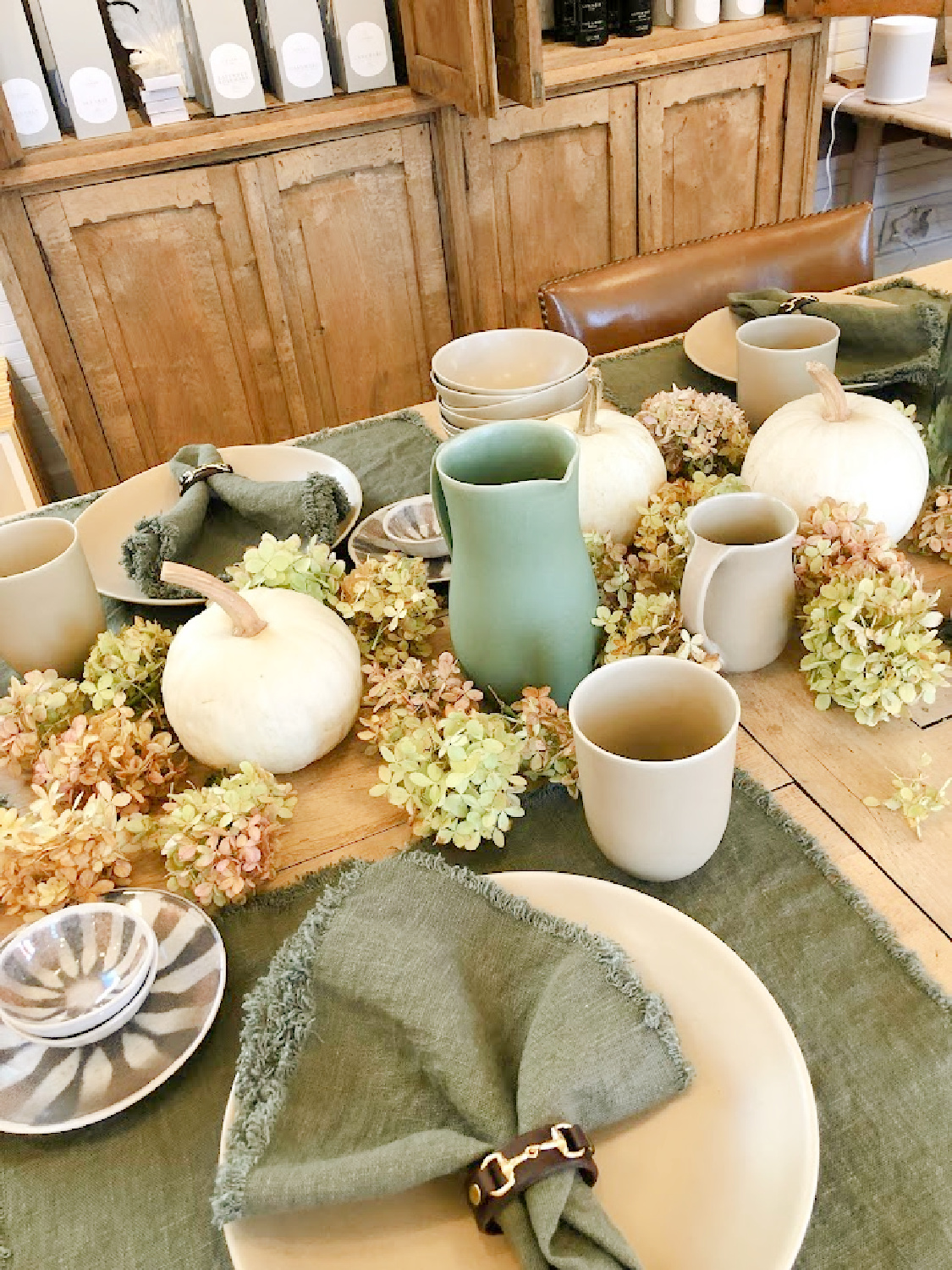 Fall tablescape with white pumpkins, French dishes, and hydrangea - Patina Home & Garden in Leiper's Fork near Franklin, TN. #patinahome