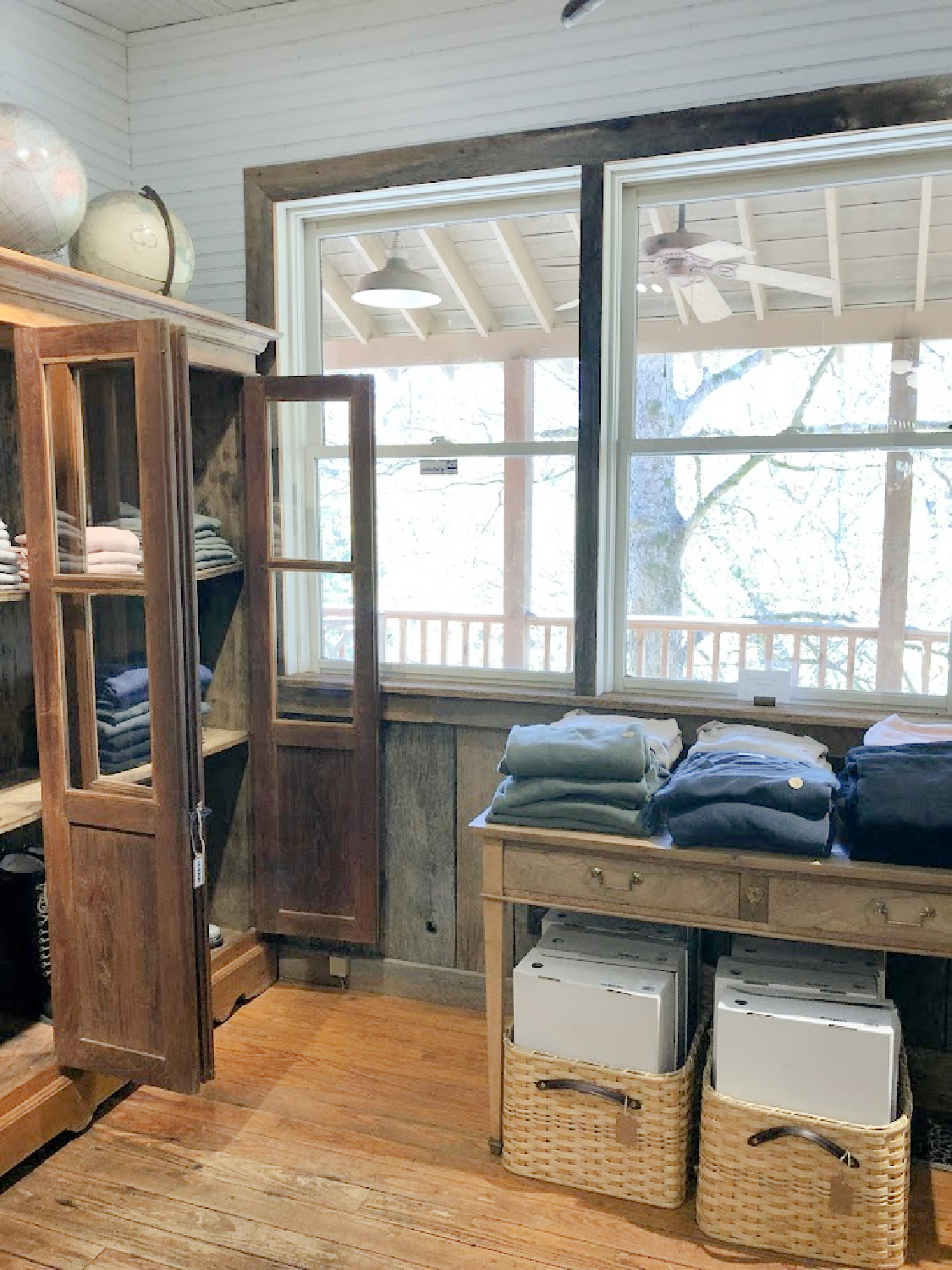 Giannetti designed clothing in antique cupboards in shop near Franklin - Patina Home & Garden shop from Giannettis in Leiper's Fork, TN - Hello Lovely Studio. #patinahome #leipersforktn