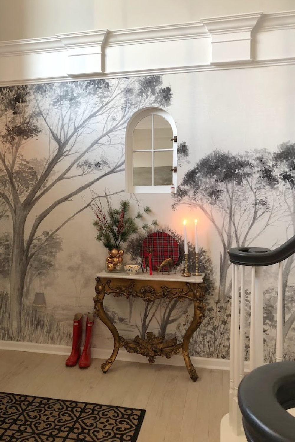 Crown molding, tree wallpaper, and marble topped antique French console table in entry with holiday decor - Hello Lovely Studio.
