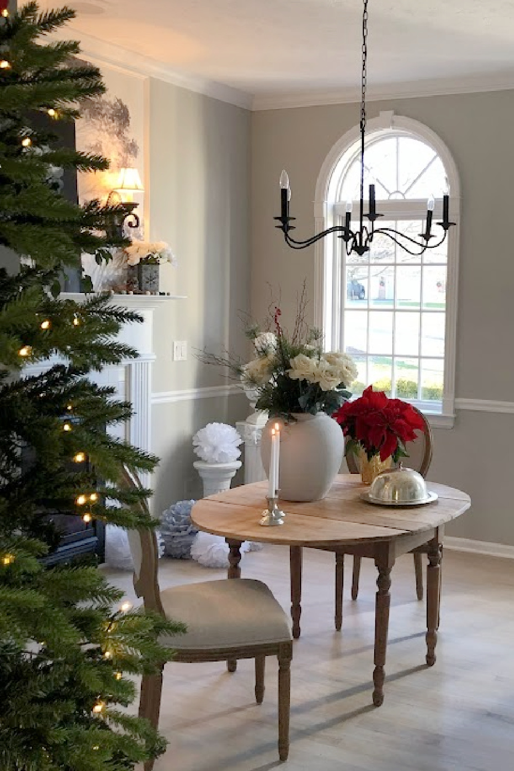 Dining room in our Georgian with holiday decor and Christmas tree nearby - Hello Lovely Studio.