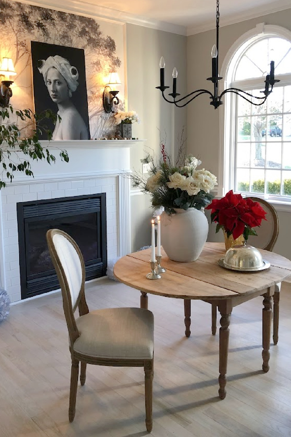 Dining room in our Georgian with holiday decor and Christmas tree nearby - Hello Lovely Studio.