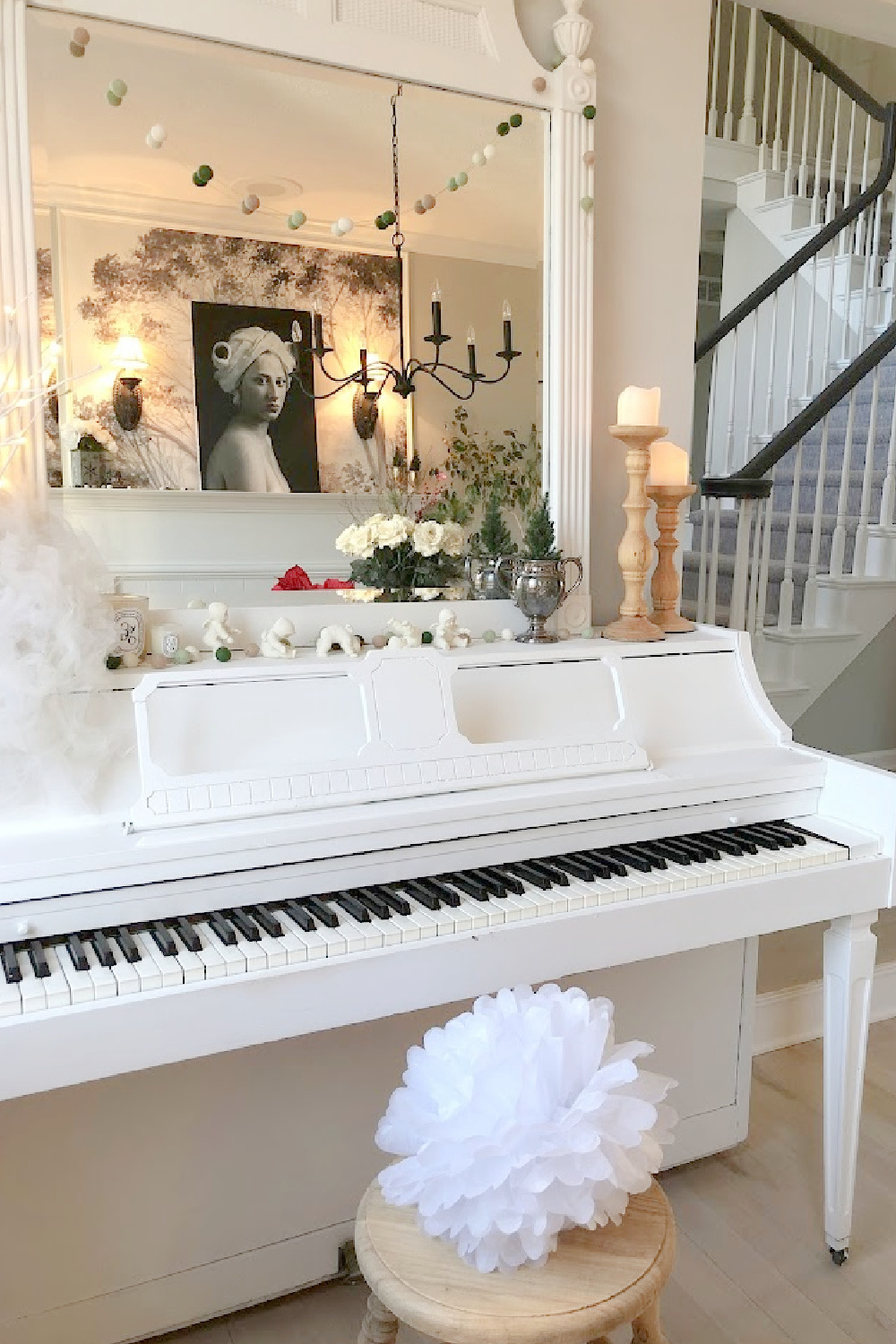 Holiday decor in our entry and dining room which feature a wallpapered tree mural, light grey stained floors, and a gentle quiet palette of serene hues - Hello Lovely Studio. #elegantchristmas #modernfrenchchristmas