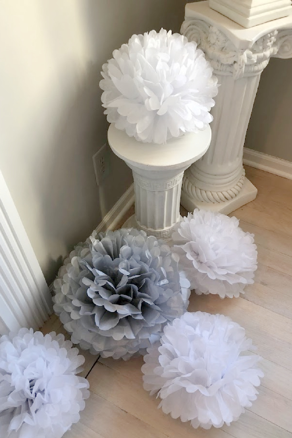 Tissue poufs were purchased to festively decorate and soften the dining room - Hello Lovely Studio.