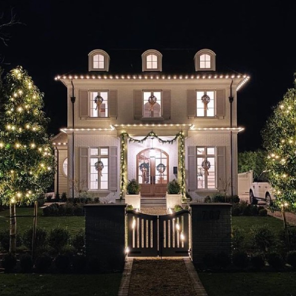 Heartwarming Christmas house exterior with French country architecture and wreaths in windows - @jennymartindesign for @lee_kristine. Photo: @platinumhdstudios. #frenchcountrychristmas