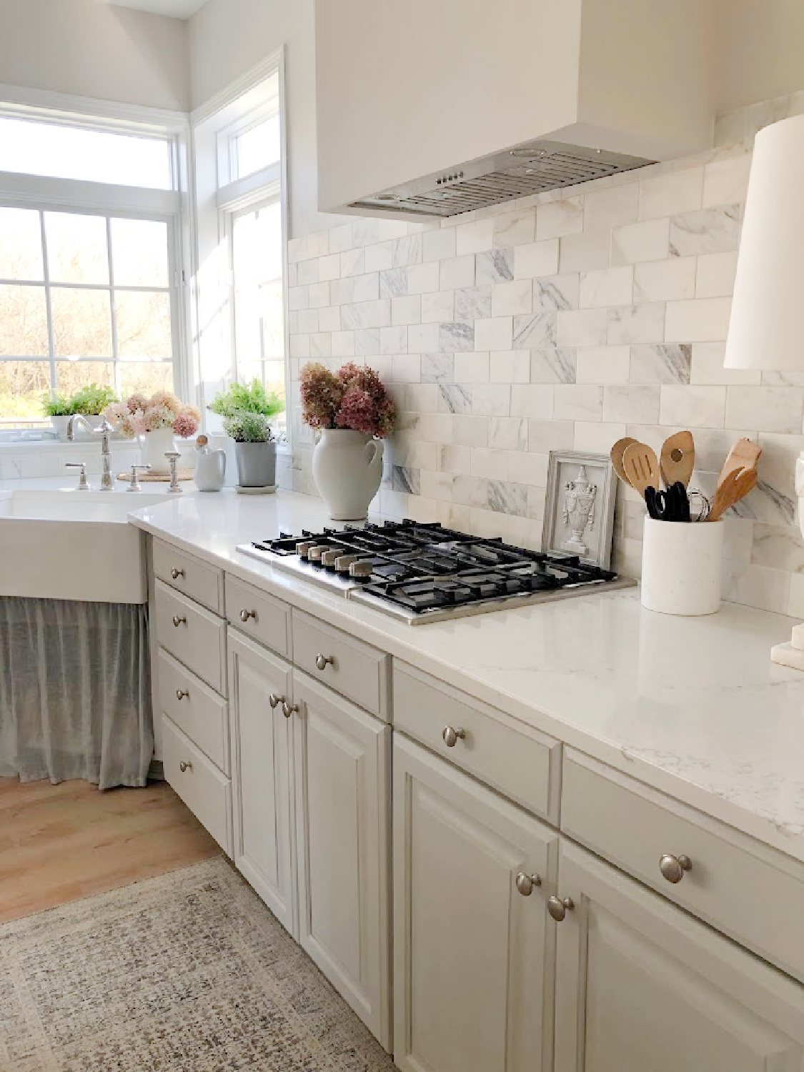Renovated kitchen with Viatera Muse countertops and Sherwin Williams Eider White paint color. Cabinets are 50% Farrow & Ball Pavilion Gray - Hello Lovely Studio.