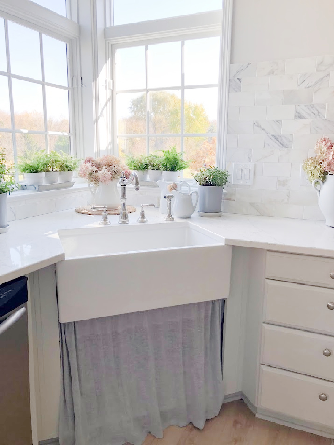 Renovated kitchen with Viatera Muse countertops and Sherwin Williams Eider White paint color. Cabinets are 50% Farrow & Ball Pavilion Gray - Hello Lovely Studio.