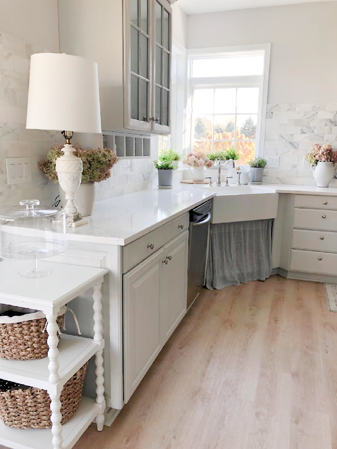 Renovated kitchen with Viatera Muse countertops and Sherwin Williams Eider White paint color. Cabinets are 50% Farrow & Ball Pavilion Gray - Hello Lovely Studio.