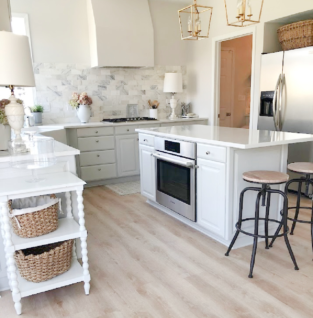 Renovated kitchen with Viatera Muse countertops and Sherwin Williams Eider White paint color. Cabinets are 50% Farrow & Ball Pavilion Gray - Hello Lovely Studio.